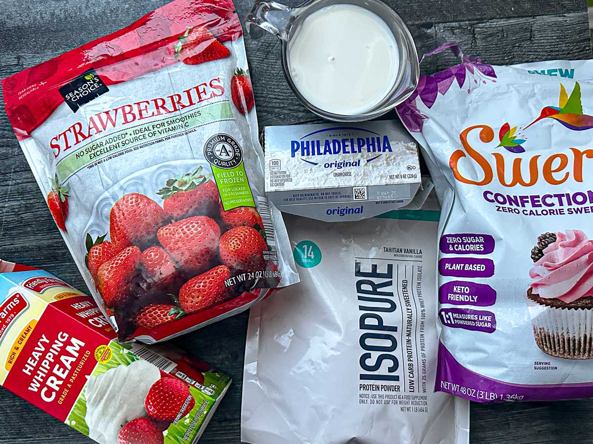 Recipe ingredients - frozen strawberries, cream, cream cheese, almond milk, protein powder and swerve sweetener.