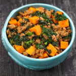 A blue bowl with the healthy sweet potato bowl with Asian flavors and text overlay.