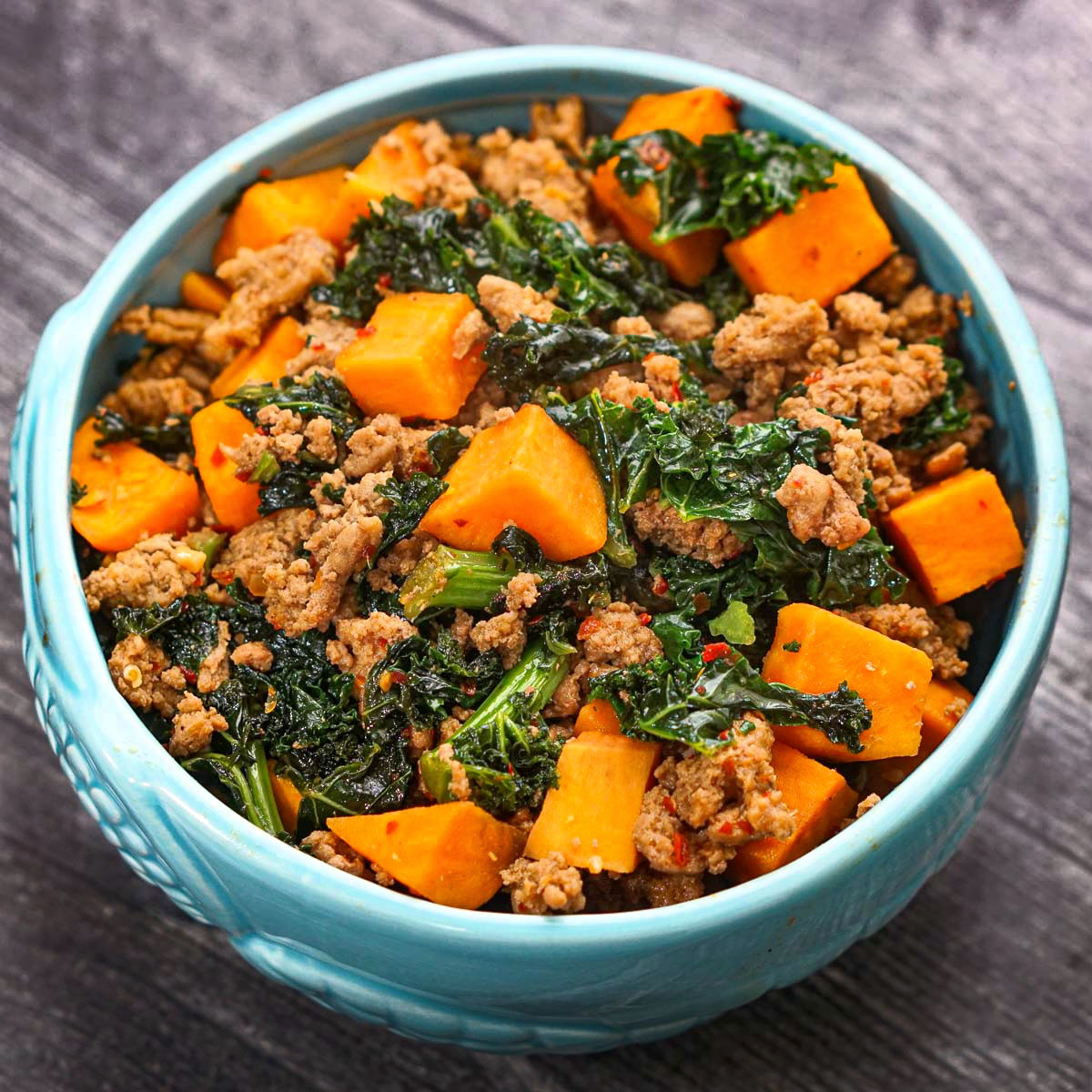 A blue bowl with the healthy sweet potato bowl with Asian flavors.