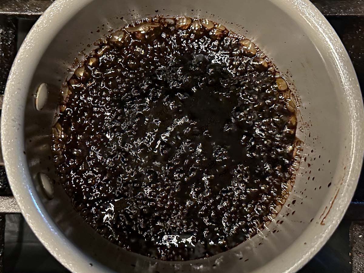 Pan with simmering balsamic sauce.
