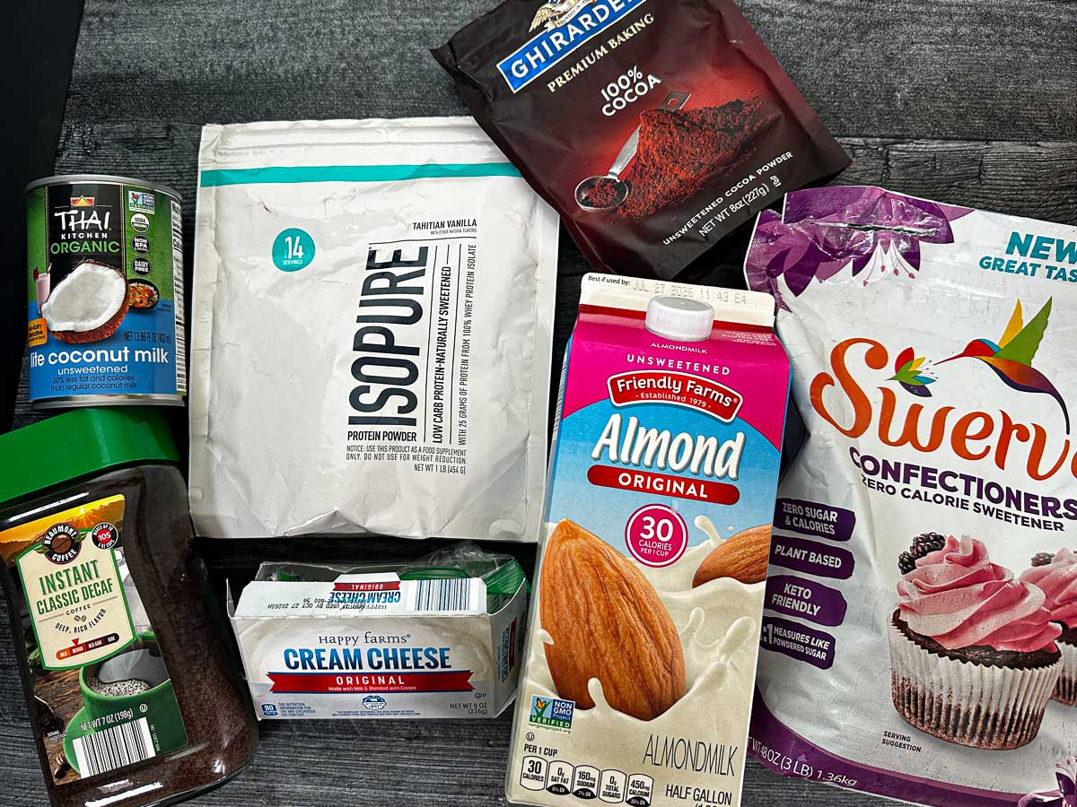 Recipe ingredients - protein powder, almond milk, sweetener, cocoa powder, coconut milk, espresso and cream cheese.