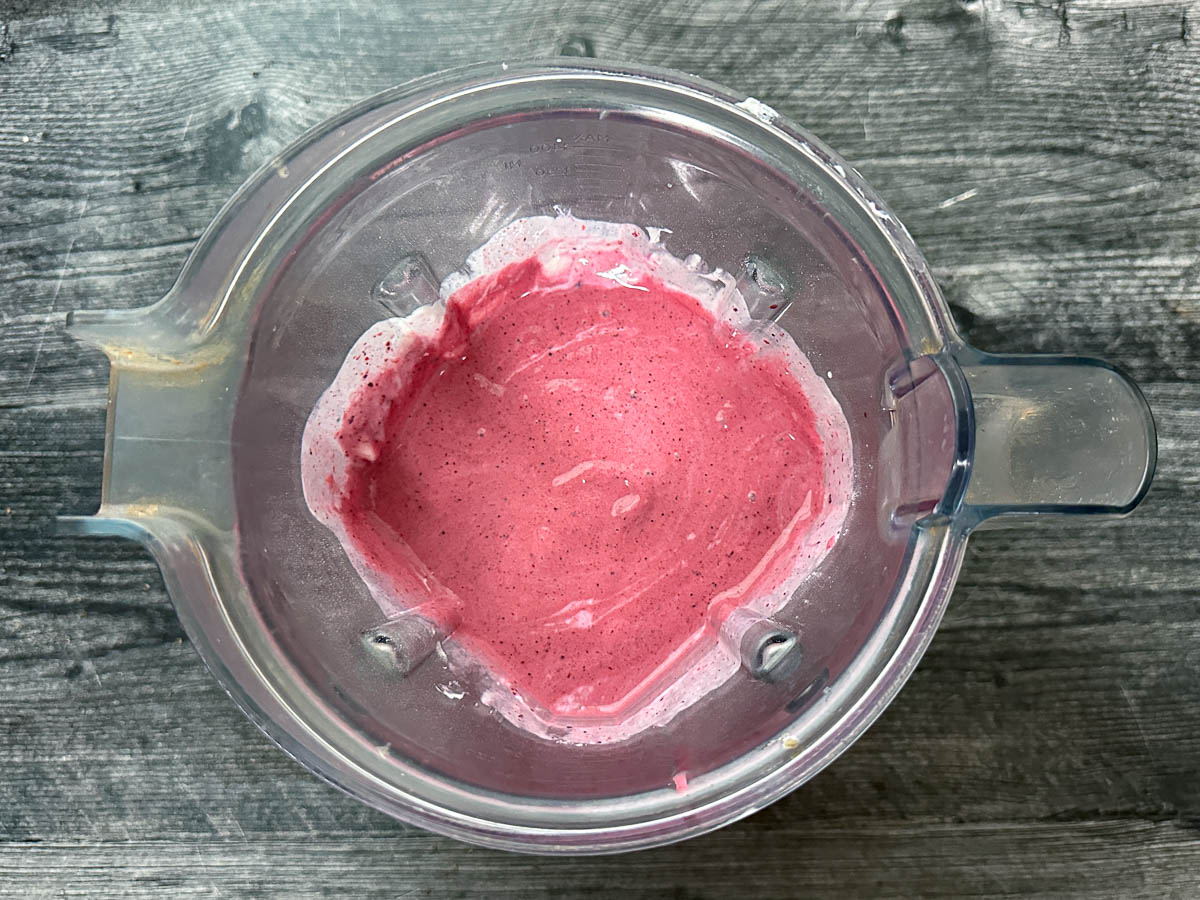 Blender pitcher with blended berries and yogurt.