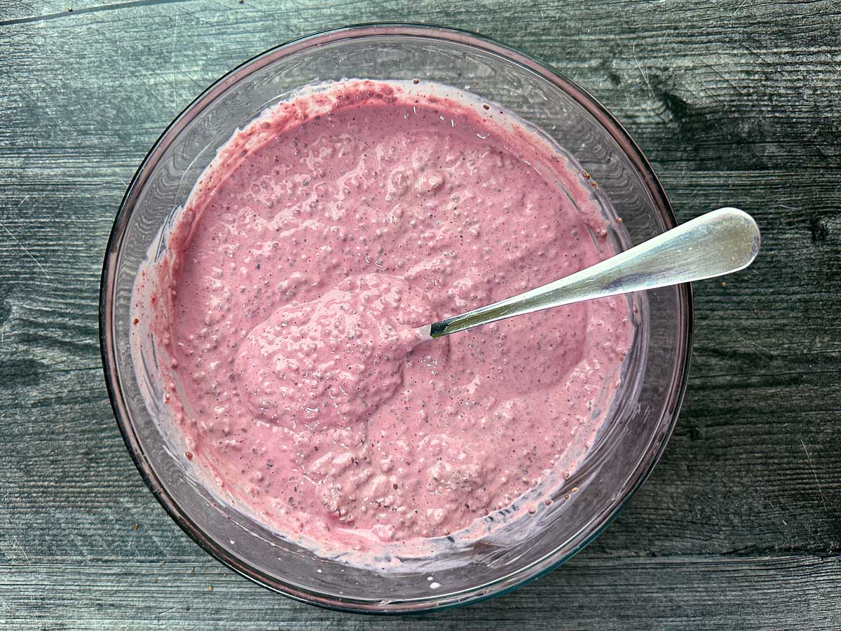 Aerial view of the finished yogurt and chia pudding with a spoon.