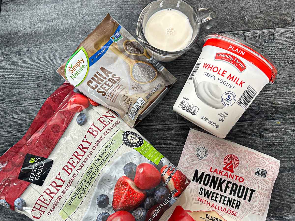 Recipe ingredients - almond milk, chia seeds, sweetener, yogurt and frozen berries.