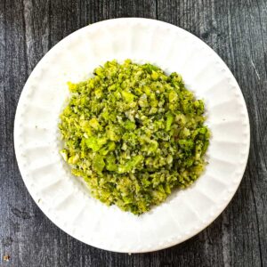 Aerial white plate with the low carb pesto broccoli cauliflower rice.
