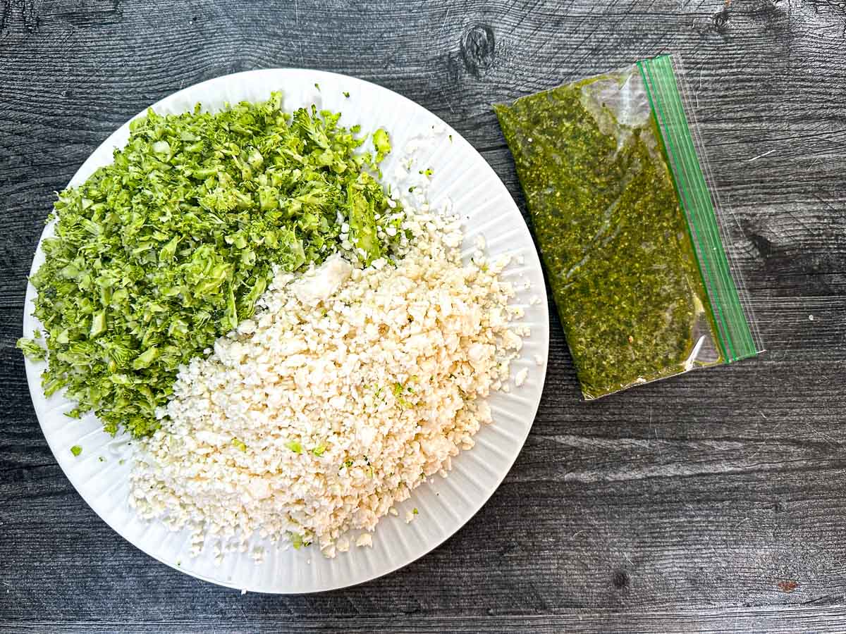 Recipe ingredients - riced broccoli and cauliflower and pesto sauce.
