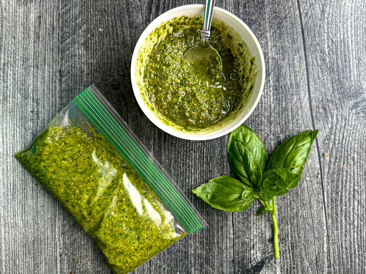 Bowl and baggie of pesto.